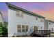 Rear view of a two-story home with a wooden deck, siding, and multiple windows at 3047 Kilarney Ridge Loop, Cary, NC 27511