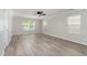 Bedroom featuring neutral paint, wood look flooring, ceiling fan and two windows at 3047 Kilarney Ridge Loop, Cary, NC 27511