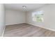 The bright bedroom features a sunny window with horizontal blinds and neutral paint at 3047 Kilarney Ridge Loop, Cary, NC 27511