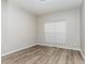 A basic bedroom space with hardwood floors, neutral paint, and a window at 3047 Kilarney Ridge Loop, Cary, NC 27511