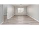 Spacious bedroom features modern, neutral paint and a sunny window with horizontal blinds at 3047 Kilarney Ridge Loop, Cary, NC 27511