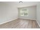 Bedroom boasts neutral paint, wood-look flooring, and a bright window at 3047 Kilarney Ridge Loop, Cary, NC 27511