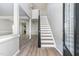 Bright entryway showcasing sleek floors, staircase, and an open floor plan, offering a welcoming atmosphere at 3047 Kilarney Ridge Loop, Cary, NC 27511