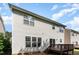 Back of home with white vinyl siding, a deck, and windows with horizontal blinds at 3047 Kilarney Ridge Loop, Cary, NC 27511
