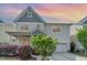 Charming two-story home featuring a welcoming porch, landscaped yard and attached garage at sunset at 3047 Kilarney Ridge Loop, Cary, NC 27511