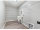 Functional laundry room with utility sink and wire shelving for storage at 3047 Kilarney Ridge Loop, Cary, NC 27511