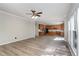 Expansive living room showcasing hardwood floors, a ceiling fan, and an open view to the kitchen at 3047 Kilarney Ridge Loop, Cary, NC 27511