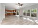 Open-concept living area with hardwood floors, ceiling fan, and an adjacent kitchen area at 3047 Kilarney Ridge Loop, Cary, NC 27511