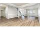 Expansive living room with sleek floors, natural light, and open layout, seamlessly connecting to other living spaces at 3047 Kilarney Ridge Loop, Cary, NC 27511