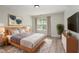 Nicely decorated main bedroom with a large window, queen bed, and stylish furnishings at 3047 Kilarney Ridge Loop, Cary, NC 27511