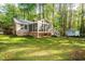 A view of the screened in porch, utility shed, and fire pit on the spacious backyard at 3217 Brennan Dr, Raleigh, NC 27613