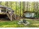 A storage building, fire pit, and stairs leading up to the deck are visible in the backyard at 3217 Brennan Dr, Raleigh, NC 27613