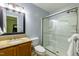 Modern bathroom featuring a glass-enclosed shower, vanity, and sleek fixtures at 3217 Brennan Dr, Raleigh, NC 27613