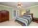 Bedroom features a large bed, ceiling fan, and natural light with access to the outside at 3217 Brennan Dr, Raleigh, NC 27613