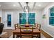 Cozy dining room with ample natural light, a wooden table, and seating for eight, perfect for Gathering meals at 3217 Brennan Dr, Raleigh, NC 27613
