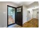 Bright and airy entryway featuring hardwood floors, neutral walls, and a view of the outdoor porch through an open door at 3217 Brennan Dr, Raleigh, NC 27613