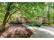 Beautiful exterior of a one-story house with a stone walkway and driveway, surrounded by lush greenery and trees at 3217 Brennan Dr, Raleigh, NC 27613