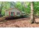 Exterior view of home with colorful flowerbeds at the front and mature trees surrounding the property at 3217 Brennan Dr, Raleigh, NC 27613