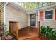 Exterior with a lovely wood porch and door, surrounded by beautiful plants and natural light at 3217 Brennan Dr, Raleigh, NC 27613