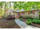 Charming one-story home with a stone walkway and colorful landscaping around the front of the house at 3217 Brennan Dr, Raleigh, NC 27613
