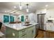 Spacious kitchen island with bar seating, stainless steel appliances, hardwood floors, and an adjacent dining area at 3217 Brennan Dr, Raleigh, NC 27613