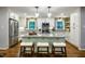 Modern kitchen featuring shaker cabinets, granite countertops, subway tile backsplash, and a spacious center island at 3217 Brennan Dr, Raleigh, NC 27613