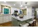 Modern kitchen with granite countertops, a large island, pendant lighting, and stainless steel appliances at 3217 Brennan Dr, Raleigh, NC 27613