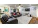 Open-concept living space features hardwood floors, neutral walls, modern furniture, and access to the kitchen at 3217 Brennan Dr, Raleigh, NC 27613