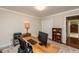 Well-lit office space with a large desk, storage, and comfortable seating at 3217 Brennan Dr, Raleigh, NC 27613