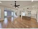 Open-concept living room and kitchen with hardwood floors, neutral paint, stairs and modern lighting at 35 Big Bear Dr, Pittsboro, NC 27312