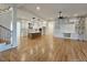 Spacious living room with hardwood floors, a built-in entertainment center, stairs and an eat-in kitchen at 35 Big Bear Dr, Pittsboro, NC 27312