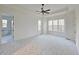 Bright main bedroom featuring a tray ceiling, carpet flooring, large windows, and ensuite bathroom at 35 Big Bear Dr, Pittsboro, NC 27312