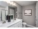 Bathroom with double vanity, granite countertop, framed mirror, and chrome fixtures at 357 Fosterton Cottage Way, Raleigh, NC 27603