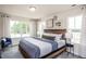 Bedroom with carpet, bright windows with curtains, and a wood-framed bed at 357 Fosterton Cottage Way, Raleigh, NC 27603