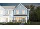Charming two-story townhome featuring a brick foundation and covered front porch at 357 Fosterton Cottage Way, Raleigh, NC 27603