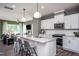 Spacious kitchen boasts an island with seating, pendant lights, and modern finishes at 357 Fosterton Cottage Way, Raleigh, NC 27603