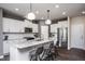 Bright kitchen features a large island, stainless appliances, and white cabinets at 357 Fosterton Cottage Way, Raleigh, NC 27603