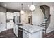 Modern kitchen with an island, stainless steel appliances, and stairs nearby at 357 Fosterton Cottage Way, Raleigh, NC 27603