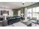 Stylish living room with a leather sofa, modern decor, and view of the dining room at 357 Fosterton Cottage Way, Raleigh, NC 27603