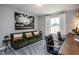 Living room with plush couch, modern art, and a work desk with 2 chairs at 357 Fosterton Cottage Way, Raleigh, NC 27603