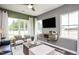 Inviting living room with large windows, modern furnishings, and a ceiling fan at 357 Fosterton Cottage Way, Raleigh, NC 27603