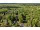An aerial view of a property nestled amidst a forest, showcasing its secluded location and natural surroundings at 359 Punch Hill Farm Rd, Rougemont, NC 27572