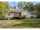 Backyard with blooming wisteria, green grass, and an external storage unit at 359 Punch Hill Farm Rd, Rougemont, NC 27572
