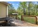 Wooden deck with metal table and chairs in the backyard with the woods at 359 Punch Hill Farm Rd, Rougemont, NC 27572