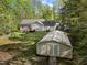 Backyard view showing the house, shed, and large lawn for outdoor activities at 359 Punch Hill Farm Rd, Rougemont, NC 27572