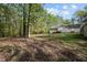 Home backyard with a large, flat grassy area, and plenty of shade trees at 359 Punch Hill Farm Rd, Rougemont, NC 27572