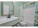 Bright bathroom with a single sink vanity and a shower and tub combination at 359 Punch Hill Farm Rd, Rougemont, NC 27572