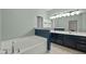 Bathroom with double vanity sinks and soaking tub at 359 Punch Hill Farm Rd, Rougemont, NC 27572