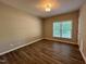This bedroom offers a scenic view from its window and boasts stylish, low-maintenance laminate flooring at 359 Punch Hill Farm Rd, Rougemont, NC 27572