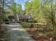 Ranch home with a gravel driveway, stone accents, and a well maintained lawn at 359 Punch Hill Farm Rd, Rougemont, NC 27572